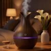 essential-oil-diffuser-nightstand-night-light Essential oil diffuser with mist on a nightstand at night
