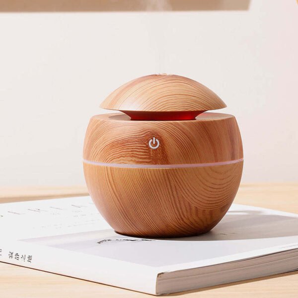 Home fragrance diffuser releasing mist in warm natural light